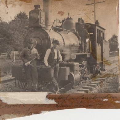 Railroad employees standing with a steam locomotive, no date. Johnson County Museum